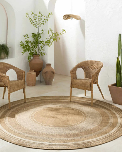 Chael Flatweave Faux Jute Outdoor Rug natural round outdoor rug with braided rings Boutique Rugs on Tampa Home & Garden Store