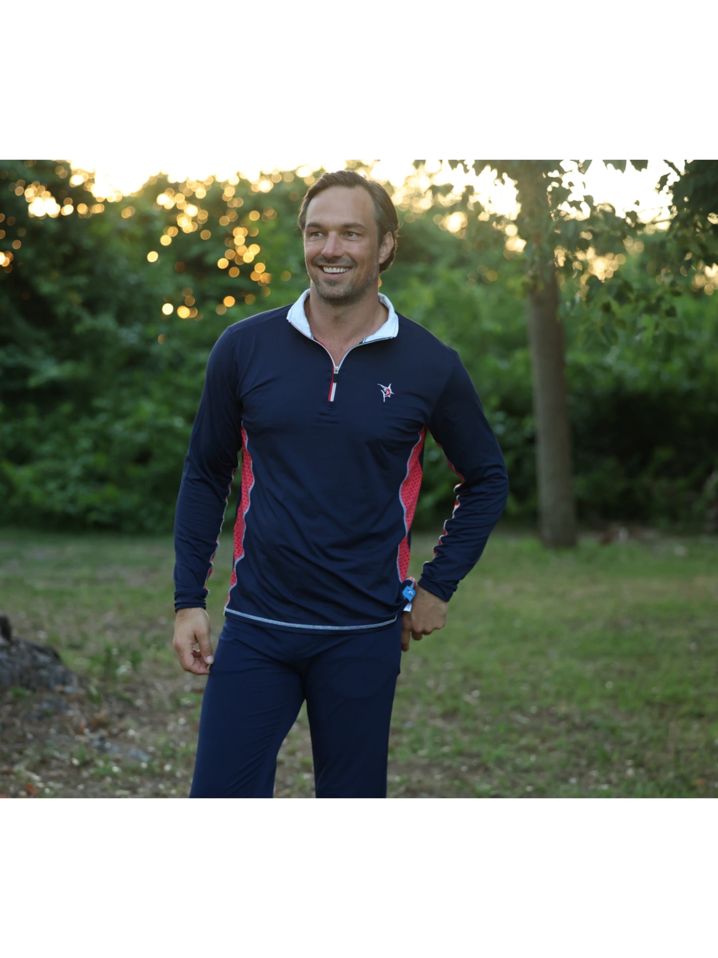 Southport navy athletic top with red side panels and white collar trim on a man outdoors on Tampa Home & Garden Store