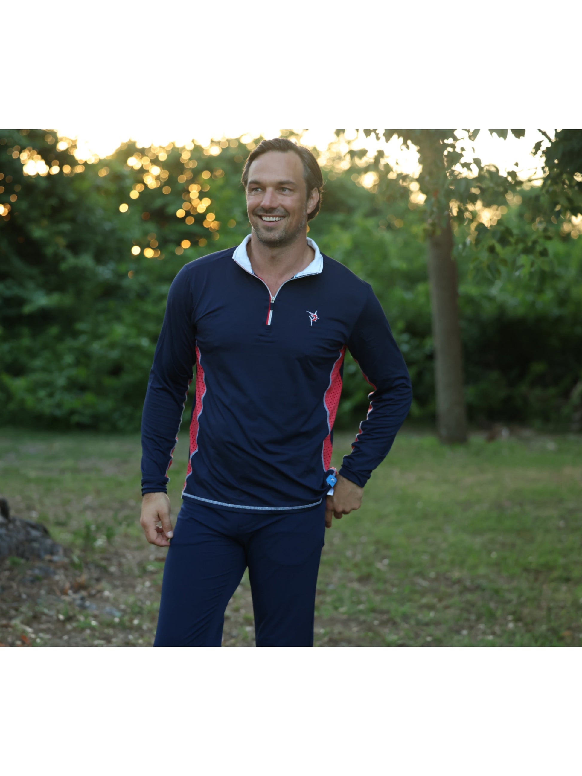 Southport navy athletic top with red side panels and white collar trim on a man outdoors on Tampa Home & Garden Store