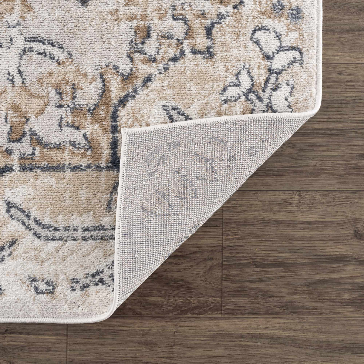 Mudgee area rug by Boutique Rugs, beige plush with gray brown abstract pattern, folded corner on Tampa Home & Garden Store