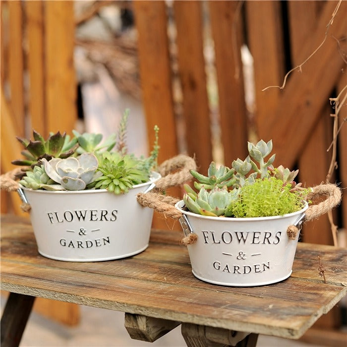 Farmhouse metal flower planters oval and round two with rope handles and succulents on Tampa Home & Garden Store