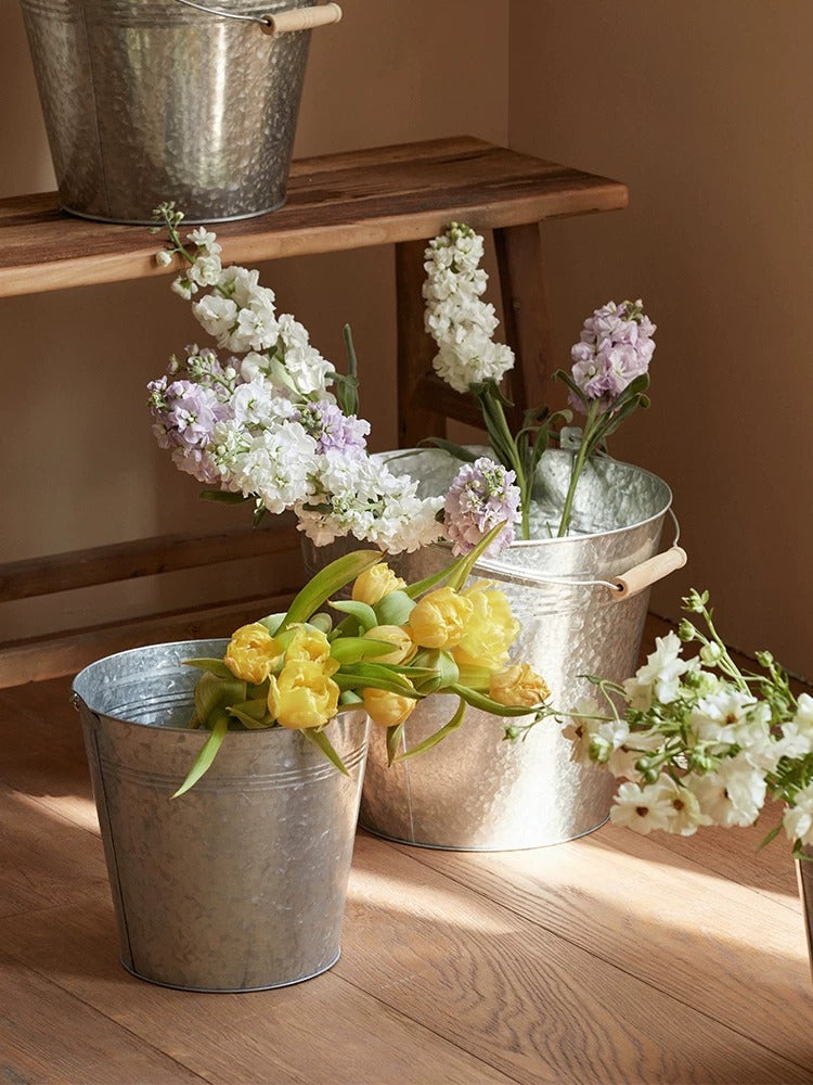 Galvanized bucket planters (3) by RusticReach with yellow tulips on Tampa Home & Garden Store