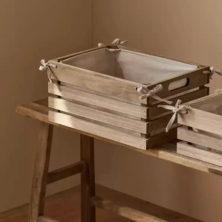 Linen-lined wooden crates set for storage by RusticReach with wood and tied linen bows on Tampa Home & Garden Store