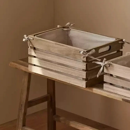 Linen-lined wooden crates set for storage by RusticReach with wood and tied linen bows on Tampa Home & Garden Store