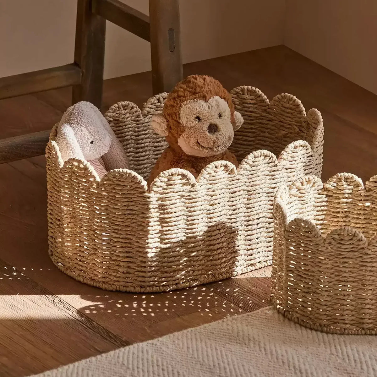 Meadow Scallop Basket by RusticReach, natural woven jute storage basket with two plush monkeys on Tampa Home & Garden Store