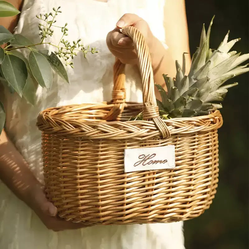 Orchard Market Basket natural woven wicker with sturdy handles, filled with greenery on Tampa Home & Garden Store