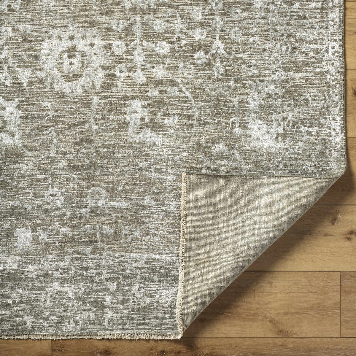 Beige Akos Area Rug - Clearance with distressed neutral pattern and fringe on hardwood on Tampa Home & Garden Store