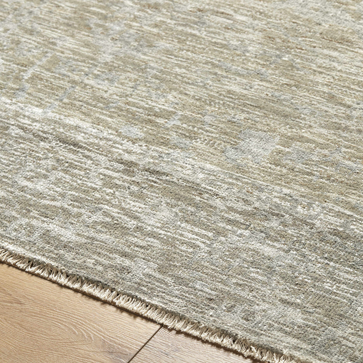 Beige Akos Area Rug by Boutique Rugs, textured beige-gray pile with fringe on Tampa Home & Garden Store