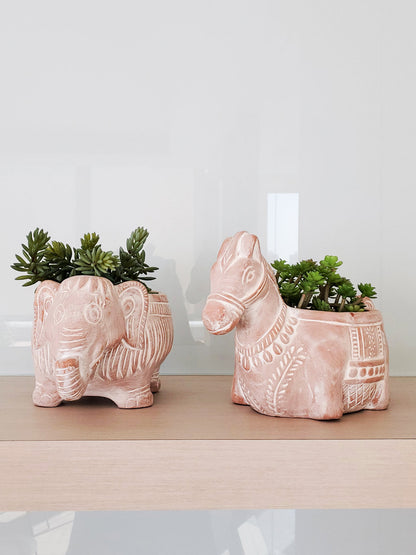 Two terracotta animal planters (horse and elephant) with succulents, Korissa Pots & Planters plant decor on shelf on Tampa Home & Garden Store