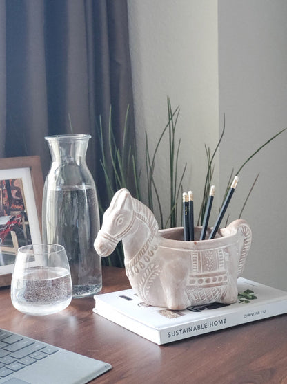 Terracotta horse-shaped planter by Korissa, decorative plant pot holding pencils on a desk on Tampa Home & Garden Store