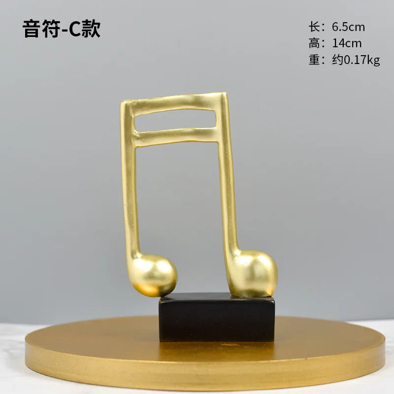 Gold-tone music note statue with black pedestal on a round gold base by Perfecsy on Tampa Home & Garden Store