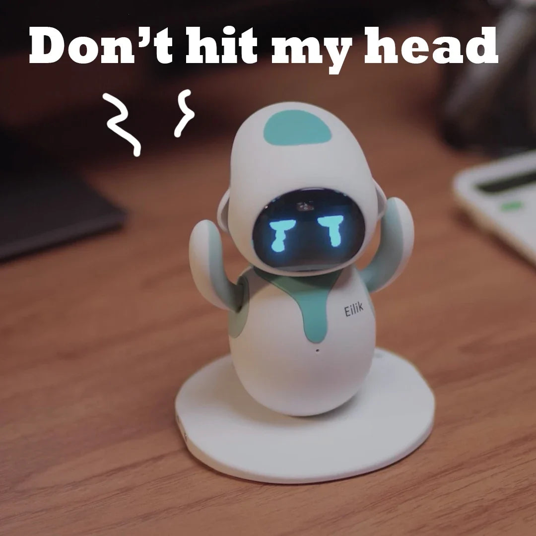 Eilik cute robot pet toy with teal accents and blue LED face, on a round white stand on Tampa Home & Garden Store