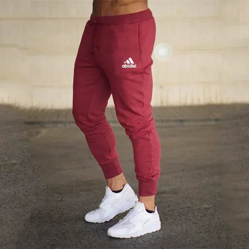 Men Joggers Pants maroon baggy sweatpants with drawstring and abidisi logo, white sneakers on Tampa Home & Garden Store
