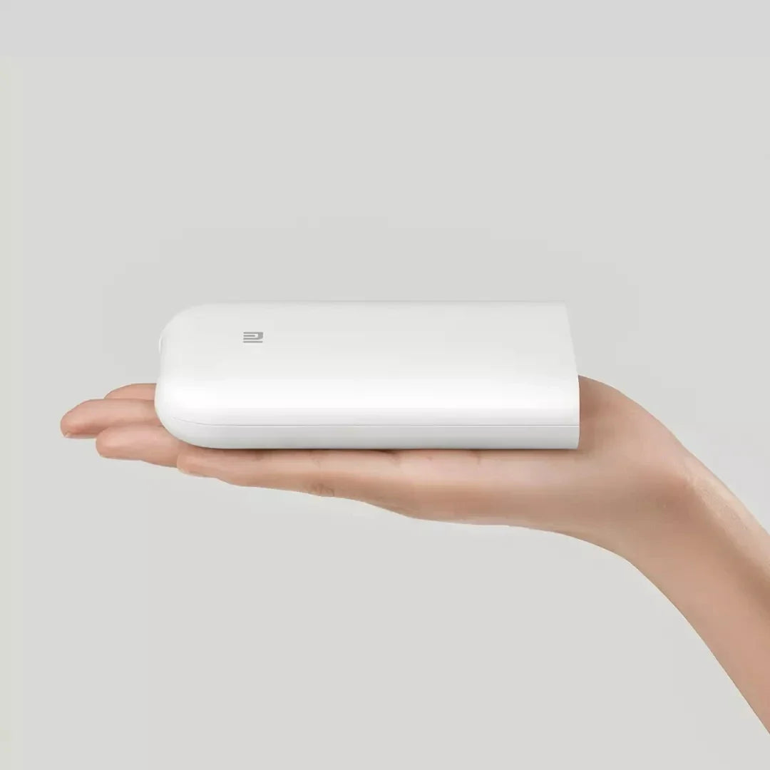 Portable mini photo printer white, pocket-size 300dpi, held in hand on Tampa Home & Garden Store