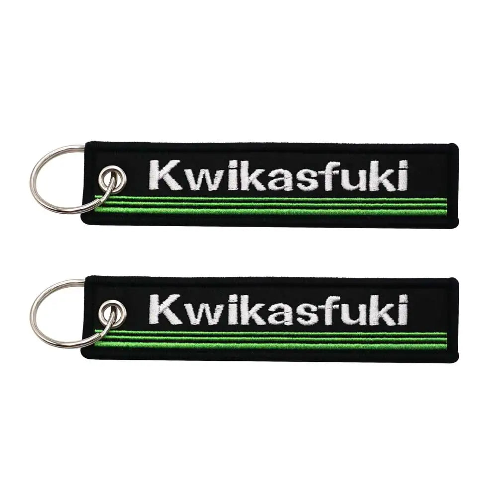 Kwikasfuki motorcycle keychains, black fabric with white embroidery and green stripe, metal rings on Tampa Home & Garden Store