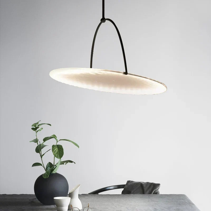 DecorBites Kepler Fabric Pendant Lamp white fabric shade with black cord over a dining table on Tampa Home & Garden Store