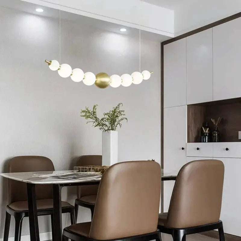 DecorBites LED pendant chandelier with white globe lights and brass globe for modern dining on Tampa Home & Garden Store