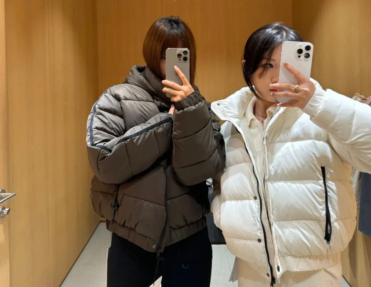 White hooded padded coat with brown puffer jacket beside models taking a mirror shot on Tampa Home & Garden Store