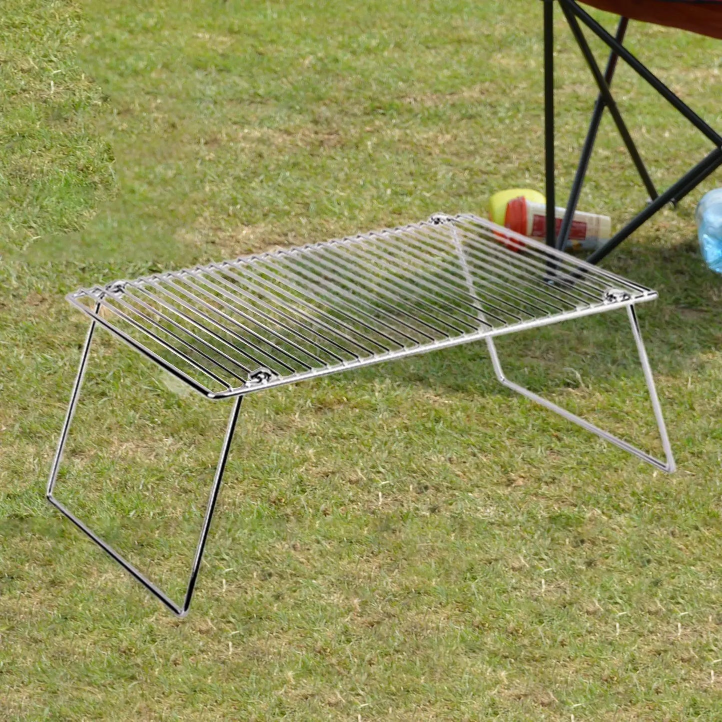 Folding campfire grill rack, stainless steel, portable camping grill for outdoor cooking on grass on Tampa Home & Garden Store
