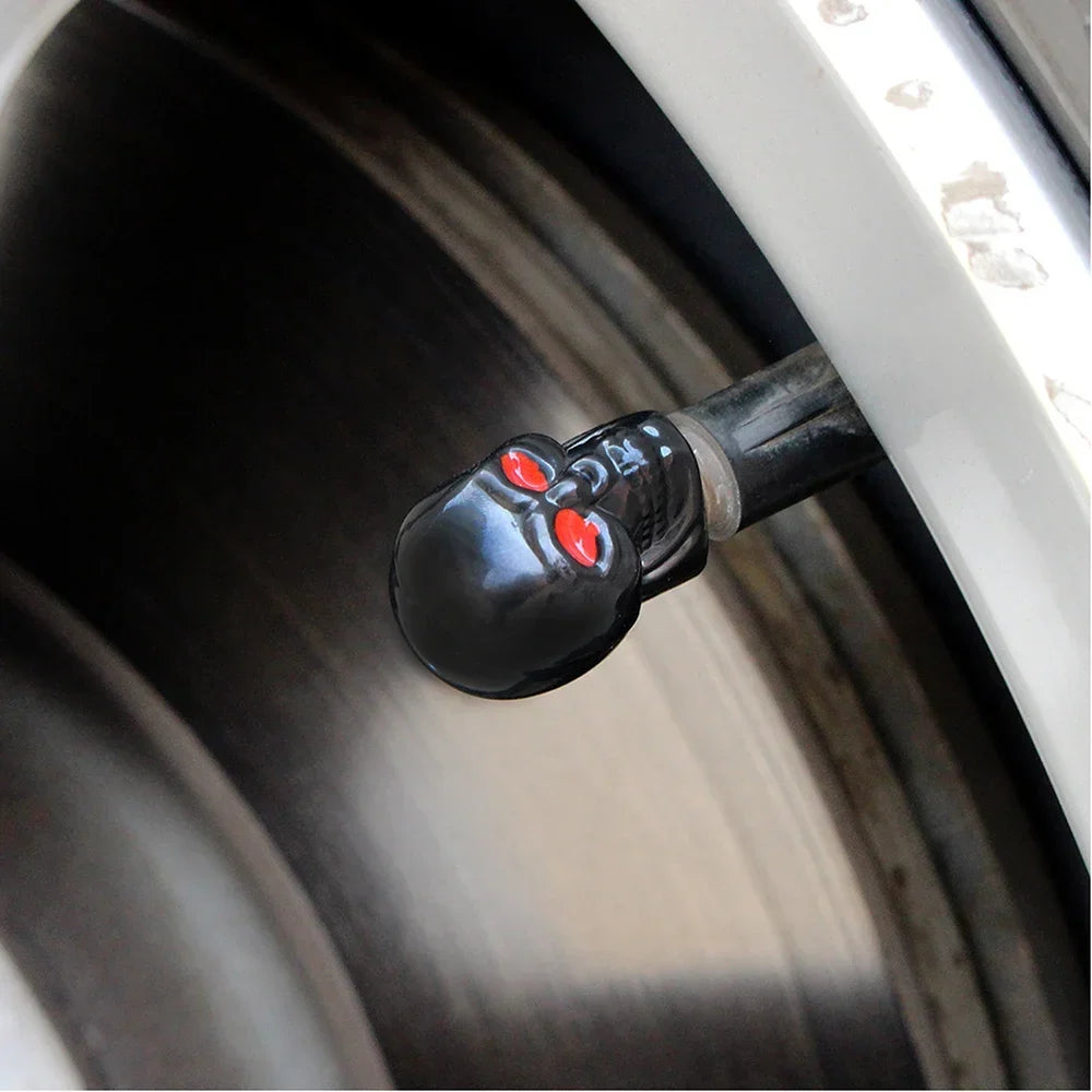 ABS Skull valve cap by BikerZoneZ in black with red eye accents on a tire valve stem on Tampa Home & Garden Store