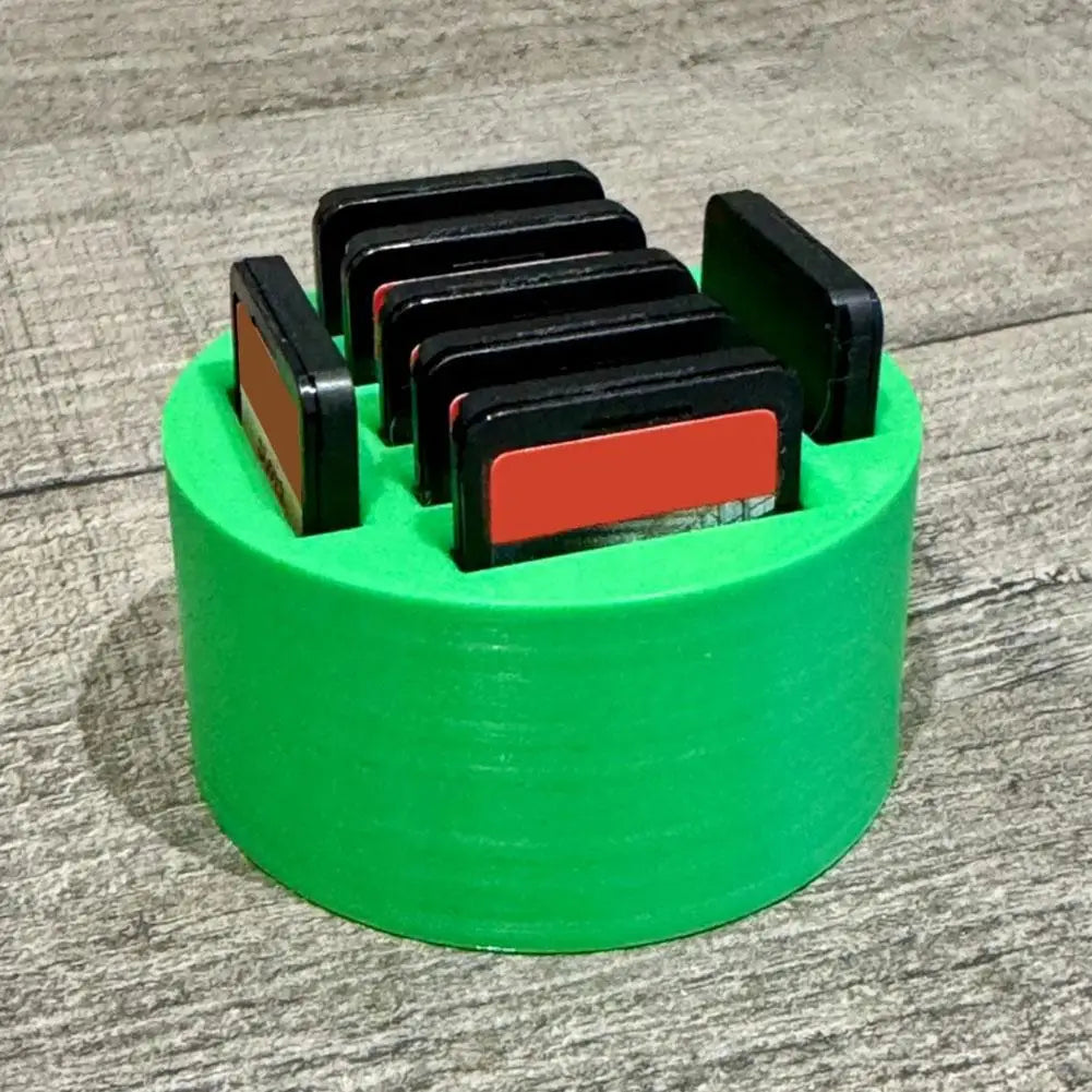 Game controller stand charging dock with black slots on a green circular base for consoles on Tampa Home & Garden Store