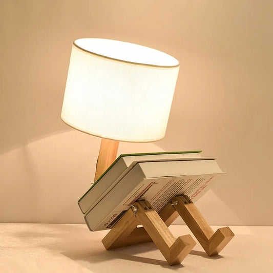 Robot-shaped wooden desk lamp with fabric shade and book-stack base on Tampa Home & Garden Store