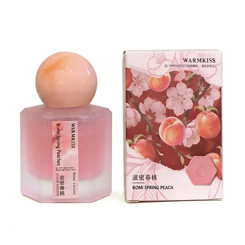 Silcy Skin Warmkiss Bomi Spring Peach perfume bottle with peach cap beside floral pink box on Tampa Home & Garden Store
