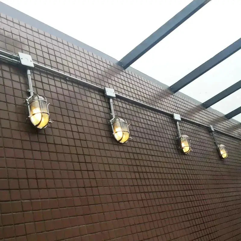 DecorBites outdoor wall lamps set, 5 lantern-style LED lights along brown tiled wall on Tampa Home & Garden Store