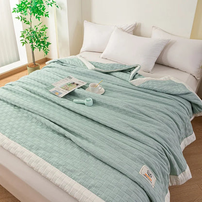 DecorBites Knitted Waffle Summer Quilt in seafoam green, breathable fabric on bed with pillows on Tampa Home & Garden Store