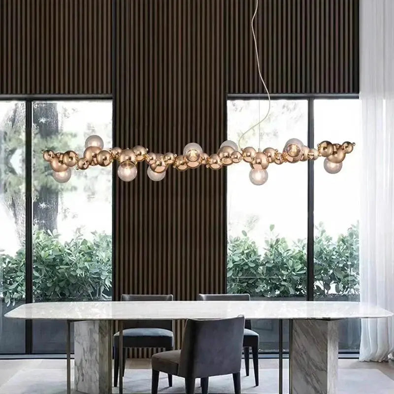 DecorBites LED pendant chandelier with gold brass bubble glass orbs over a marble dining table on Tampa Home & Garden Store