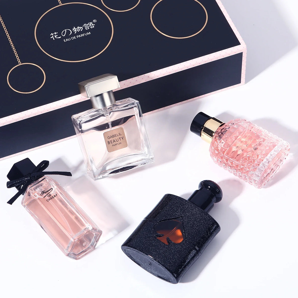 Original Women's Perfume 105ml four-piece set with clear square and pink ribbed bottles on navy gift box on Tampa Home & Garden Store