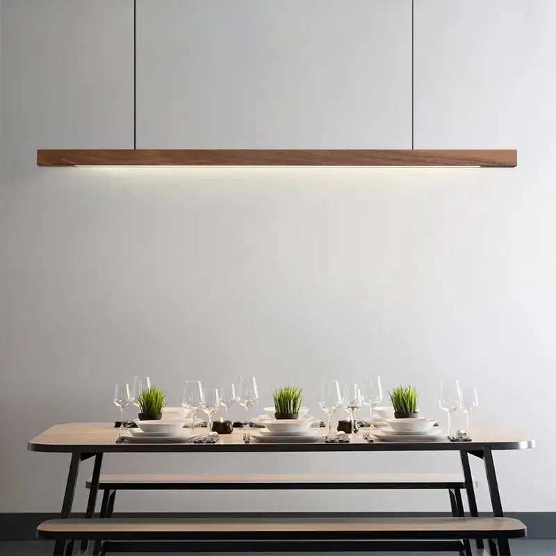 DecorBites Linear LED Pendant Lights wooden beam over a modern dining table with benches on Tampa Home & Garden Store