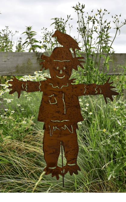 rust-colored metal outdoor scarecrow garden stake with outstretched arms on Tampa Home & Garden Store
