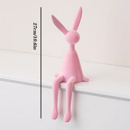 Resin flocked rabbit statue in pink with long ears, handmade bunny decor on a white shelf on Tampa Home & Garden Store