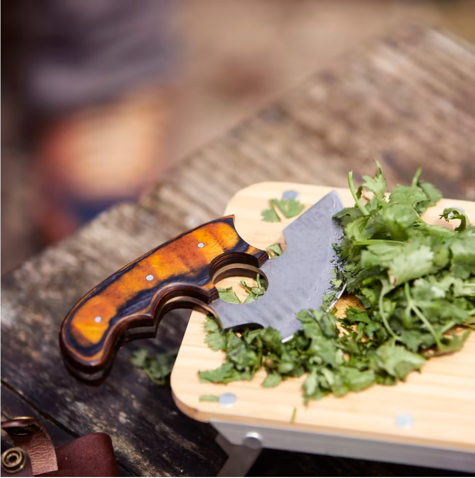 Titan Custom Alaskan Ulu damascus blade with orange-brown wood handle on cutting board on Tampa Home & Garden Store