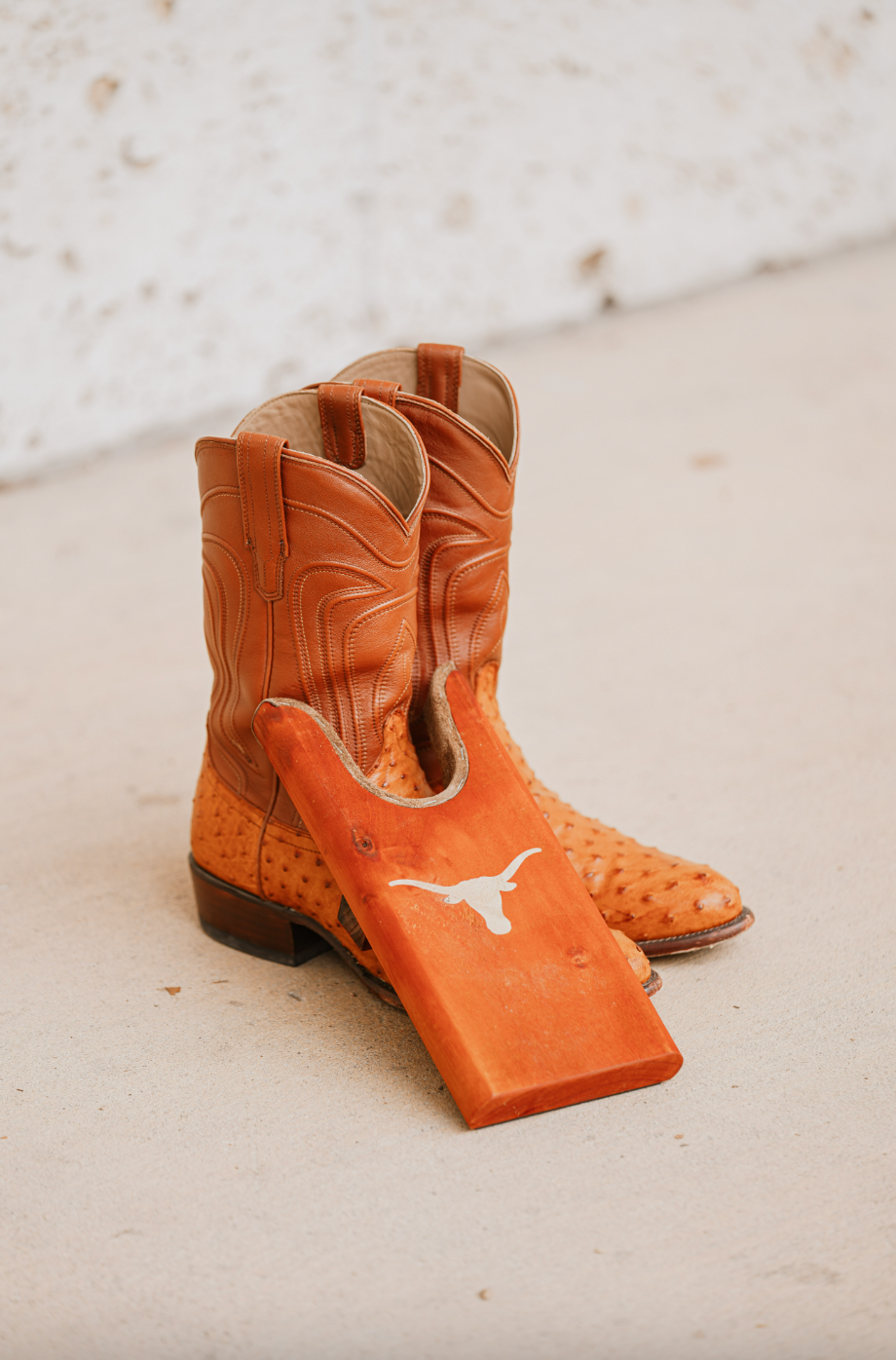 Texas Longhorn Boot Jack by Ryan's Woodworking; orange boot pull with longhorn logo beside boots on Tampa Home & Garden Store