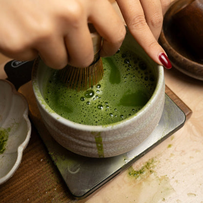Bamboo Matcha Whisk (Chasen) by isshiki matcha, whisking green matcha in a ceramic bowl on Tampa Home & Garden Store