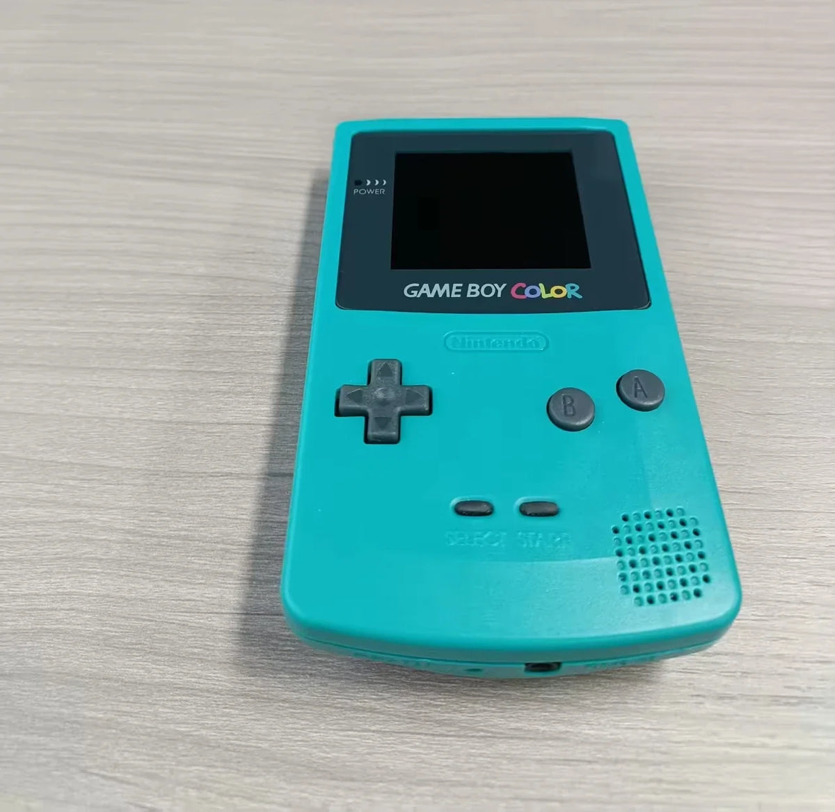 Game Boy Color handheld console teal with IPS screen, D-pad and A/B buttons on Tampa Home & Garden Store