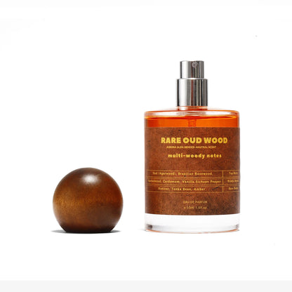 Rare Oud Wood perfume bottle with orange liquid and metal spray top on brown label on Tampa Home & Garden Store