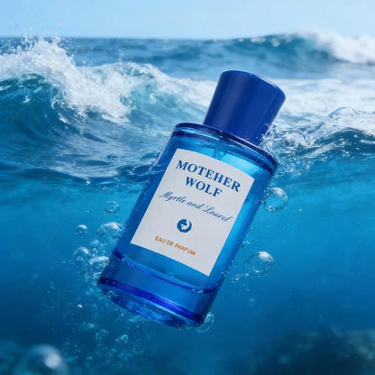 Blue glass perfume bottle with Mother Wolf Myrtle and Laurel label, floating in sea waves on Tampa Home & Garden Store