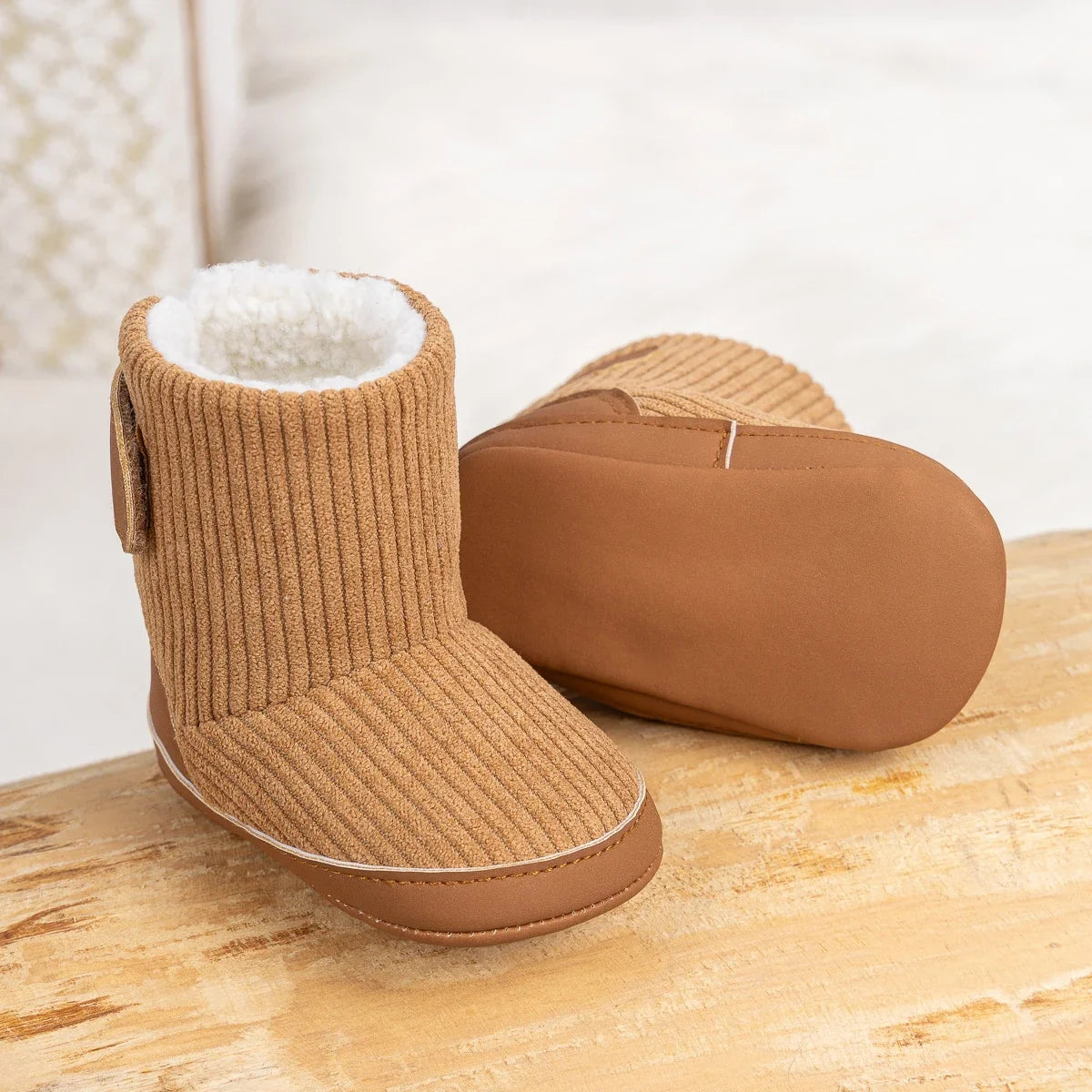 Newborn winter boots pair, tan corduroy booties with white fleece lining and rubber sole on Tampa Home & Garden Store