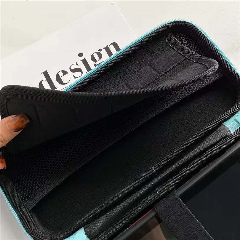 Switch OLED storage case with turquoise exterior and black interior, mesh pouch on Tampa Home & Garden Store