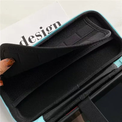 Switch OLED storage case with turquoise exterior and black interior, mesh pouch on Tampa Home & Garden Store
