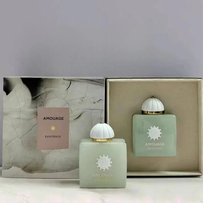 Two pale green AMOUAGE perfume bottles with white domed caps and gold trim in a gift box on Tampa Home & Garden Store