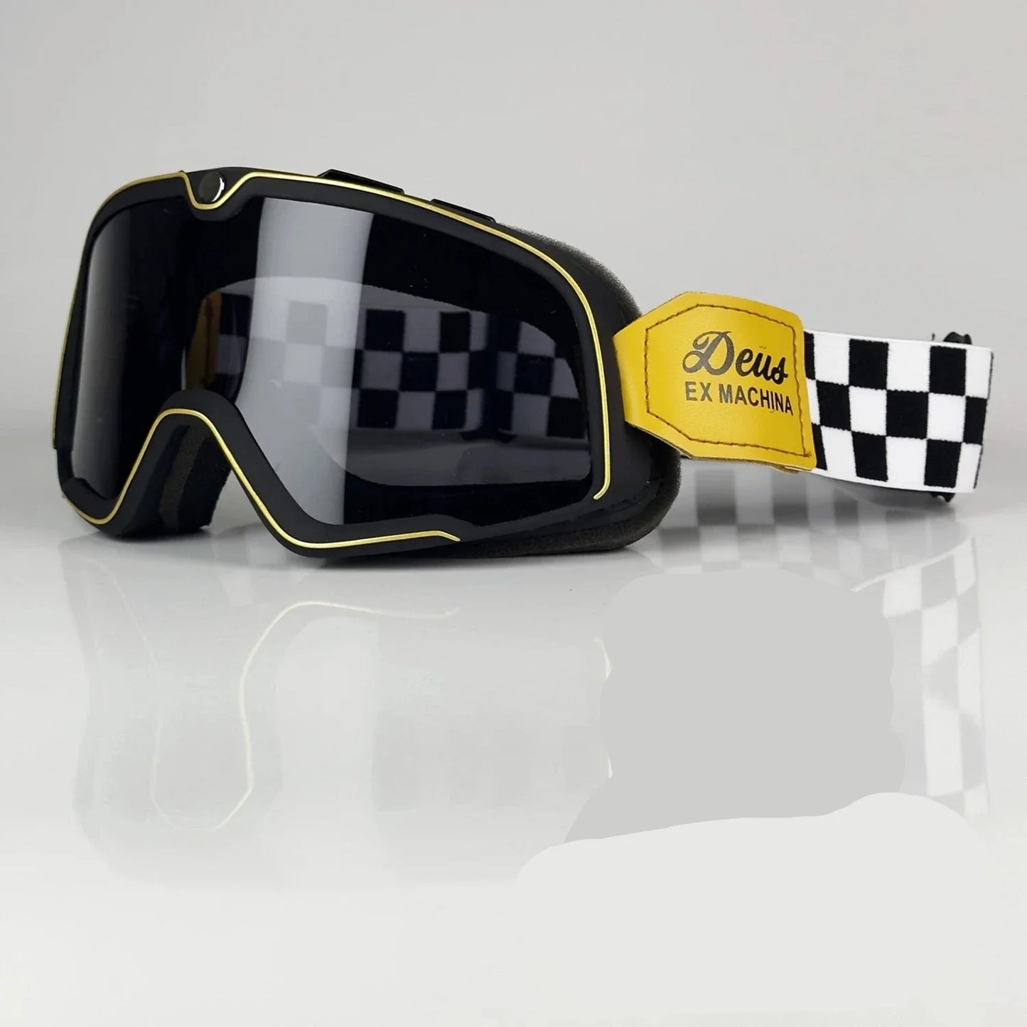 Retro motocross goggles black frame with gold trim, mirrored lens, and Deus Ex Machina strap on Tampa Home & Garden Store