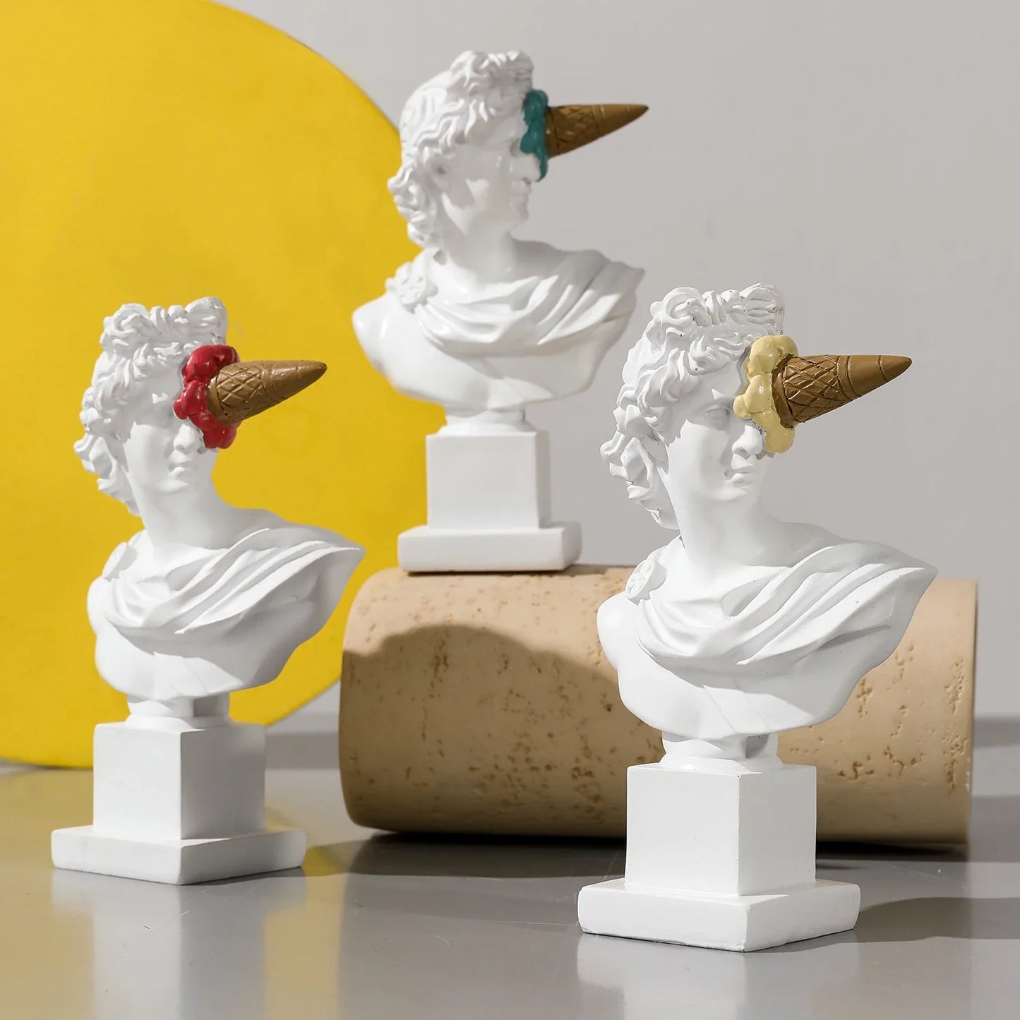 Apollo resin busts by Perfecsy with ice cream cone hats, three white statues on pedestals on Tampa Home & Garden Store