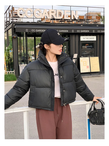 Women's cropped black cotton-padded puffer jacket by UpTrend Deals, worn with cap and brown pants on Tampa Home & Garden Store