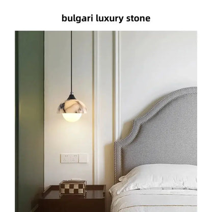 DecorBites LED pendant lamp adjustable wire globe with marble shade beside bed tufted headboard on Tampa Home & Garden Store