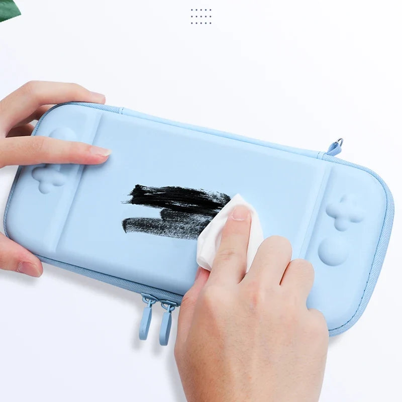 Blue 3-in-1 Switch Lite hard carry case with cute thumb grip covers, being wiped clean on Tampa Home & Garden Store