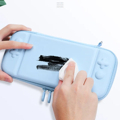 Blue 3-in-1 Switch Lite hard carry case with cute thumb grip covers, being wiped clean on Tampa Home & Garden Store